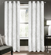 White blackout curtains set of 2 hanging on window in modern room