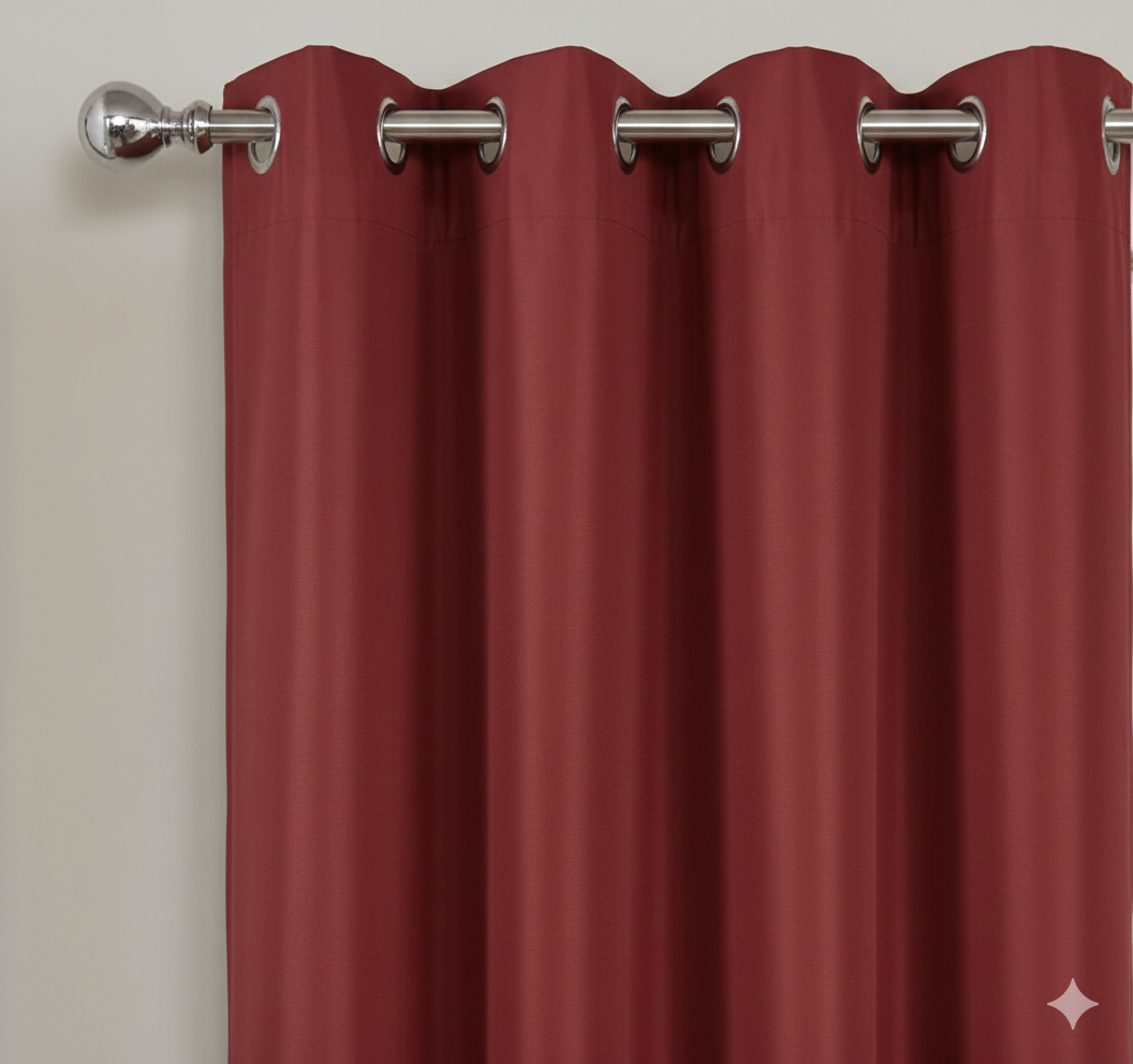 Red semi-blackout curtains with metal grommets on curtain rod